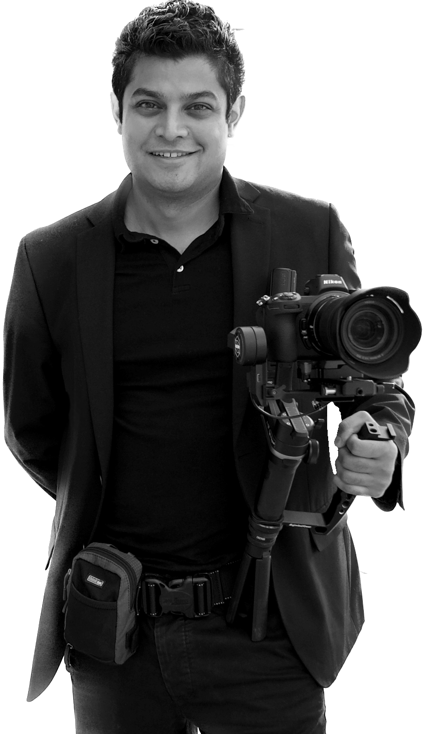 Nitesh Mistry, full-length portrait holding a gimbal-mounted camera rig