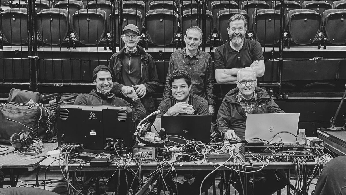 Nitesh with the wider production crew at a technical desk