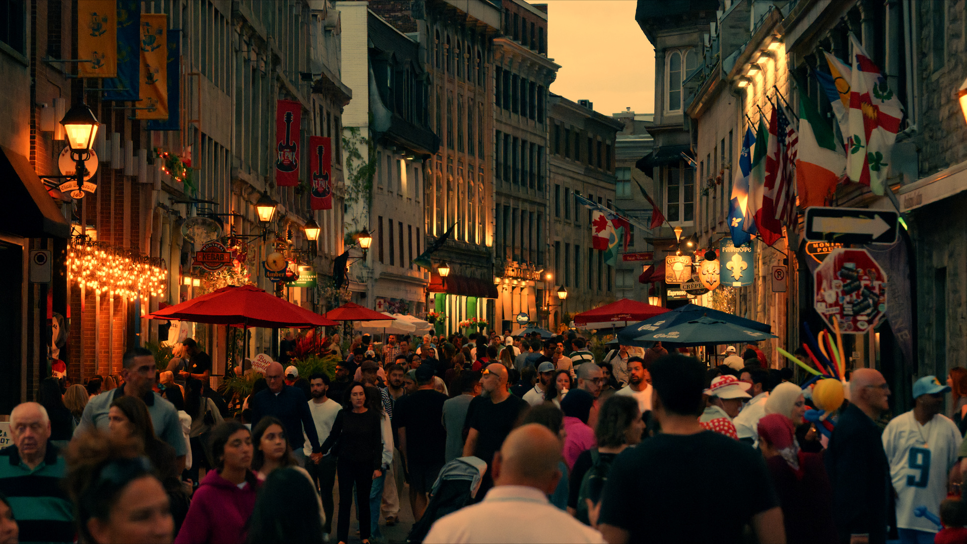 Rue Saint-Paul at dusk, crowded with people and café umbrellas, still from R3D NE footage