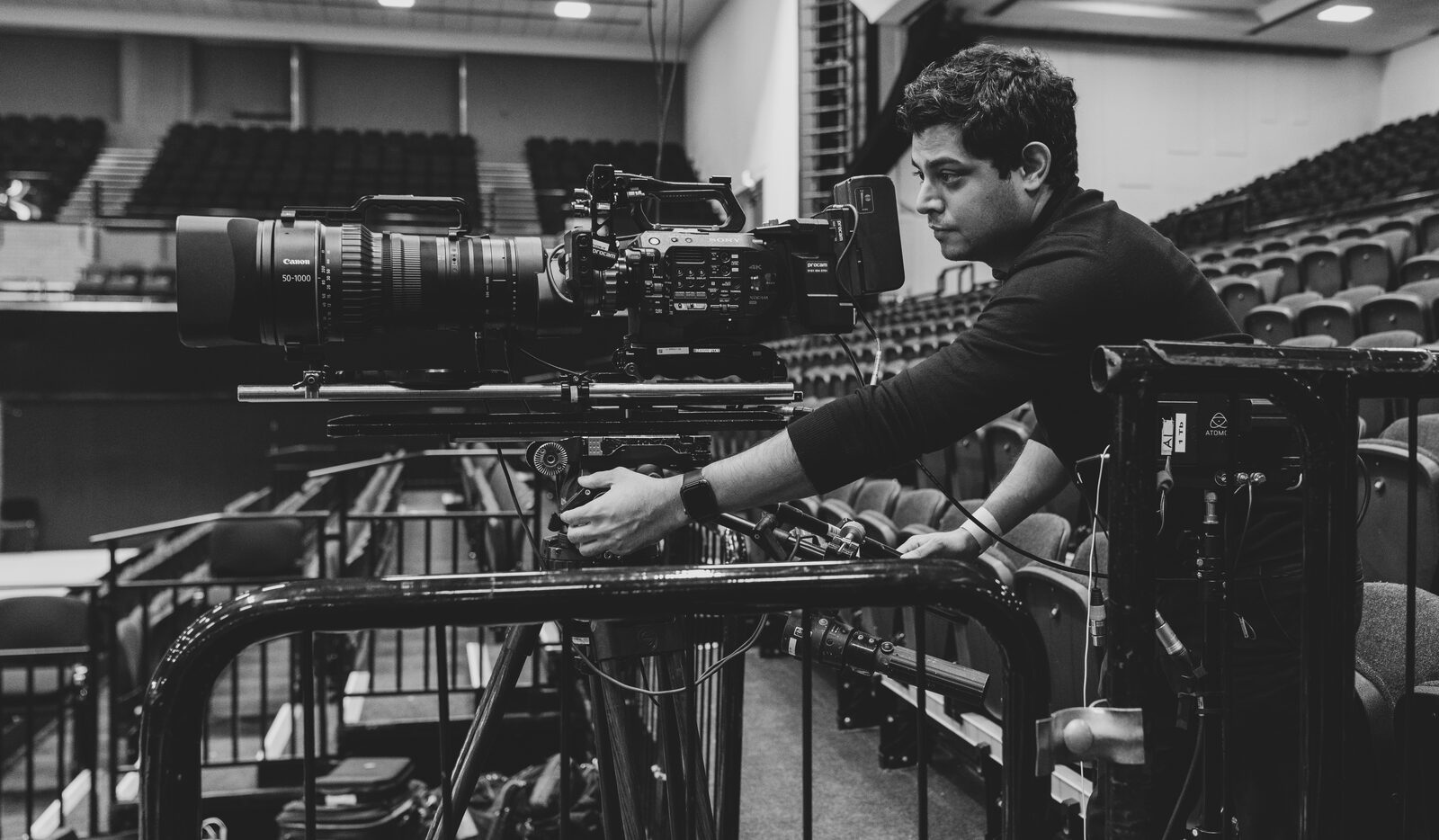 Nitesh operating a broadcast camera rig at a live event