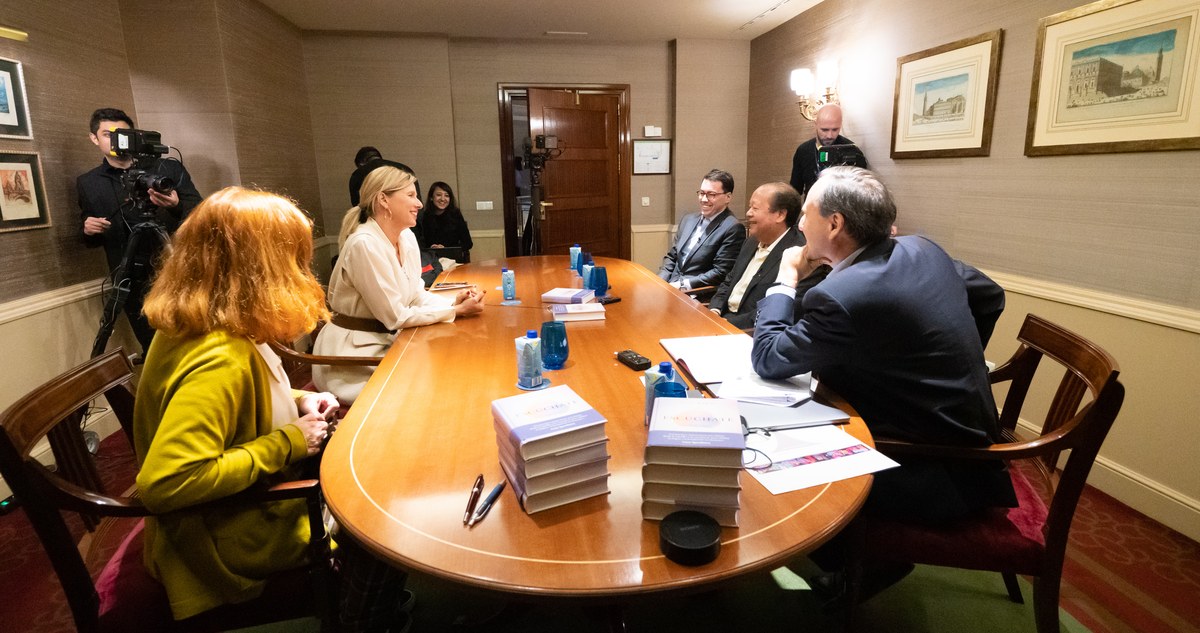 Filming a panel interview around a boardroom table